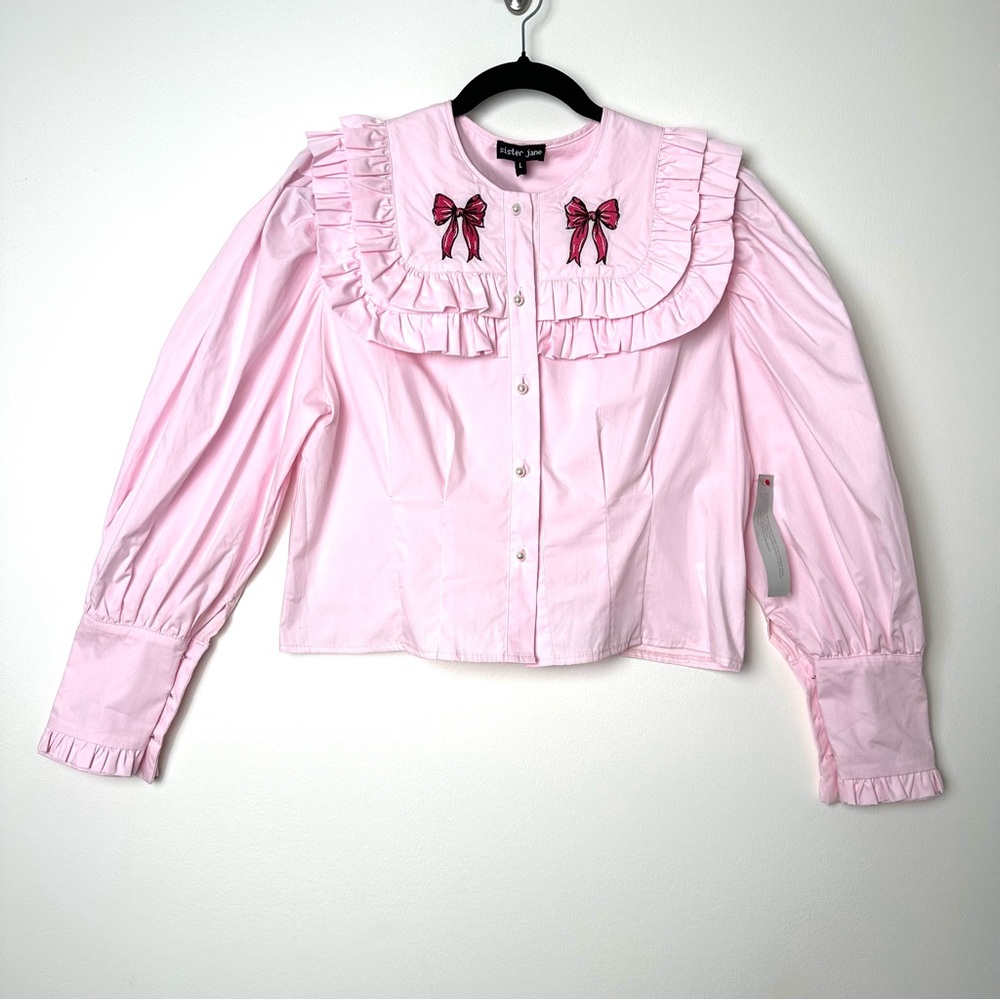 Sister Jane Baby Pink Ruffled Bib Puff Sleeve Embroidered Bow Pearl Blouse